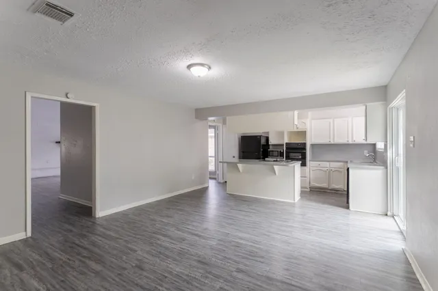 a view of a living room kitchen and a sink