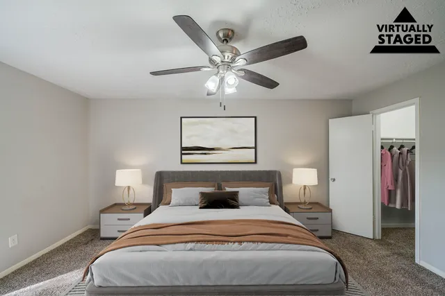 a bedroom with a bed and a chandelier