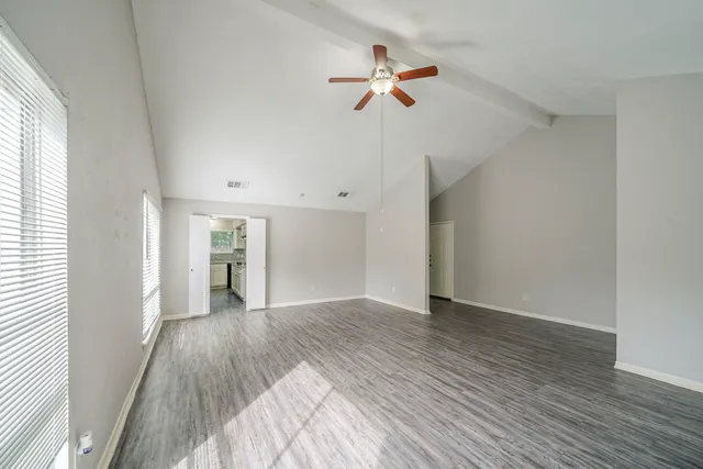 wooden floor in an empty room with a window