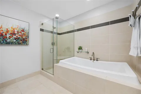 a bathroom with a bathtub and a shower