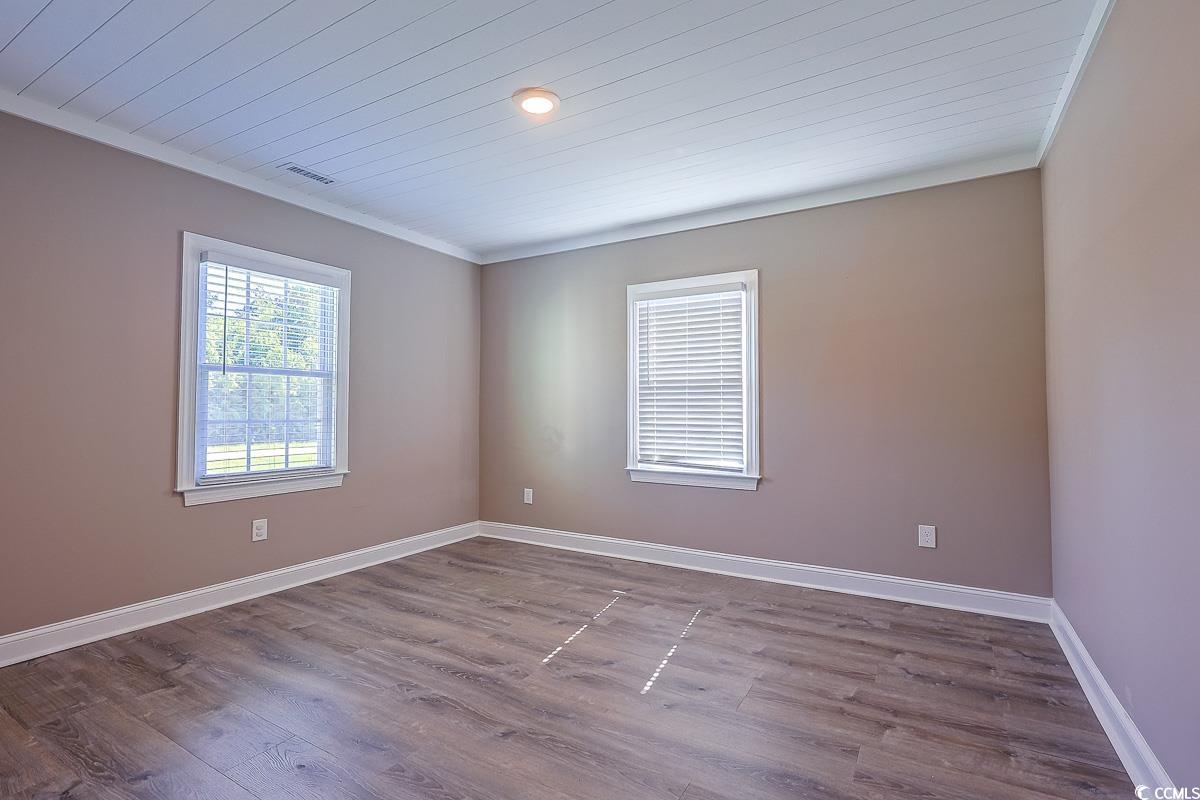201 Math Place Little River, SC 29566 - Photo 25 of 40 Unfurnished room with dark wood-type flooring, crown molding, and recessed lighting