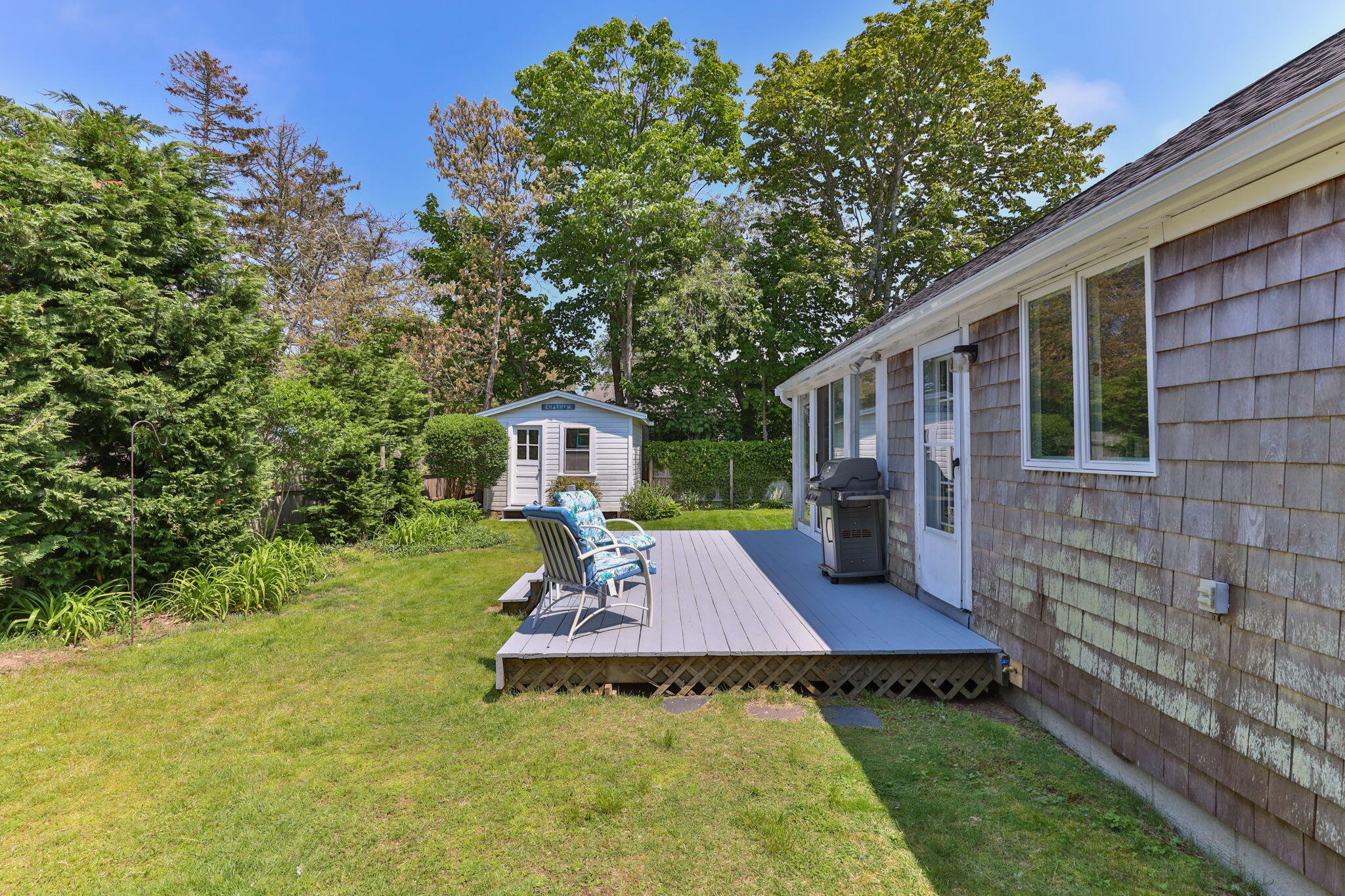 7 Aunt Matties Road Chatham, MA 02633 - Photo 32 of 37 a view of a wooden deck and a yard