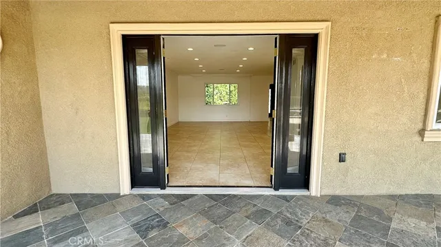 a balcony with table and chairs
