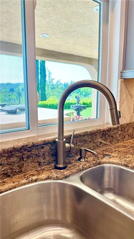 a bathroom with a granite countertop sink a toilet and a mirror