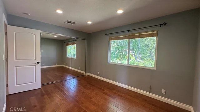a view of a patio with table and chairs floor to ceiling window with wooden floor