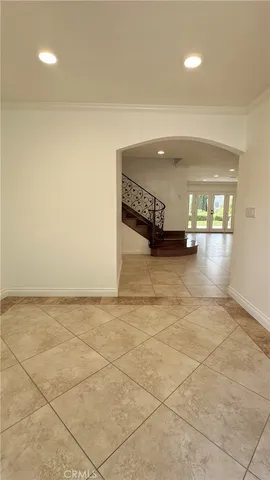 a view of an empty room with a fireplace and a window