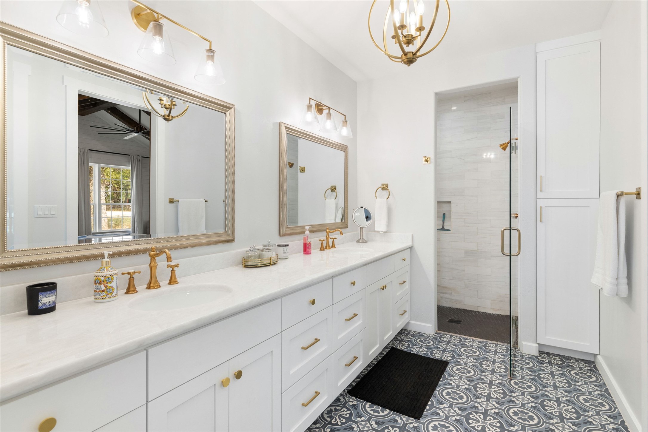 810 Kothmann Road Dripping Springs, TX 78620 - Photo 18 of 40 Patterned tile flooring and a long double vanity anchor this elegant washroom.