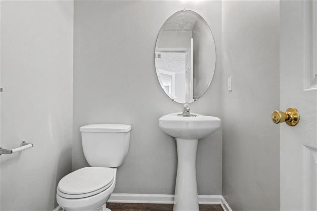 4612 Grand Central Parkway Decatur, GA 30035 - Photo 6 of 10 a bathroom with a toilet sink and mirror