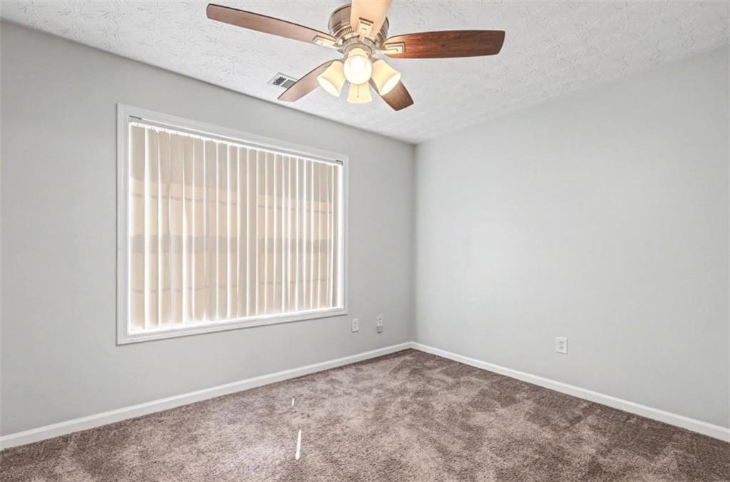 4612 Grand Central Parkway Decatur, GA 30035 - Photo 10 of 10 an empty room with windows and fan