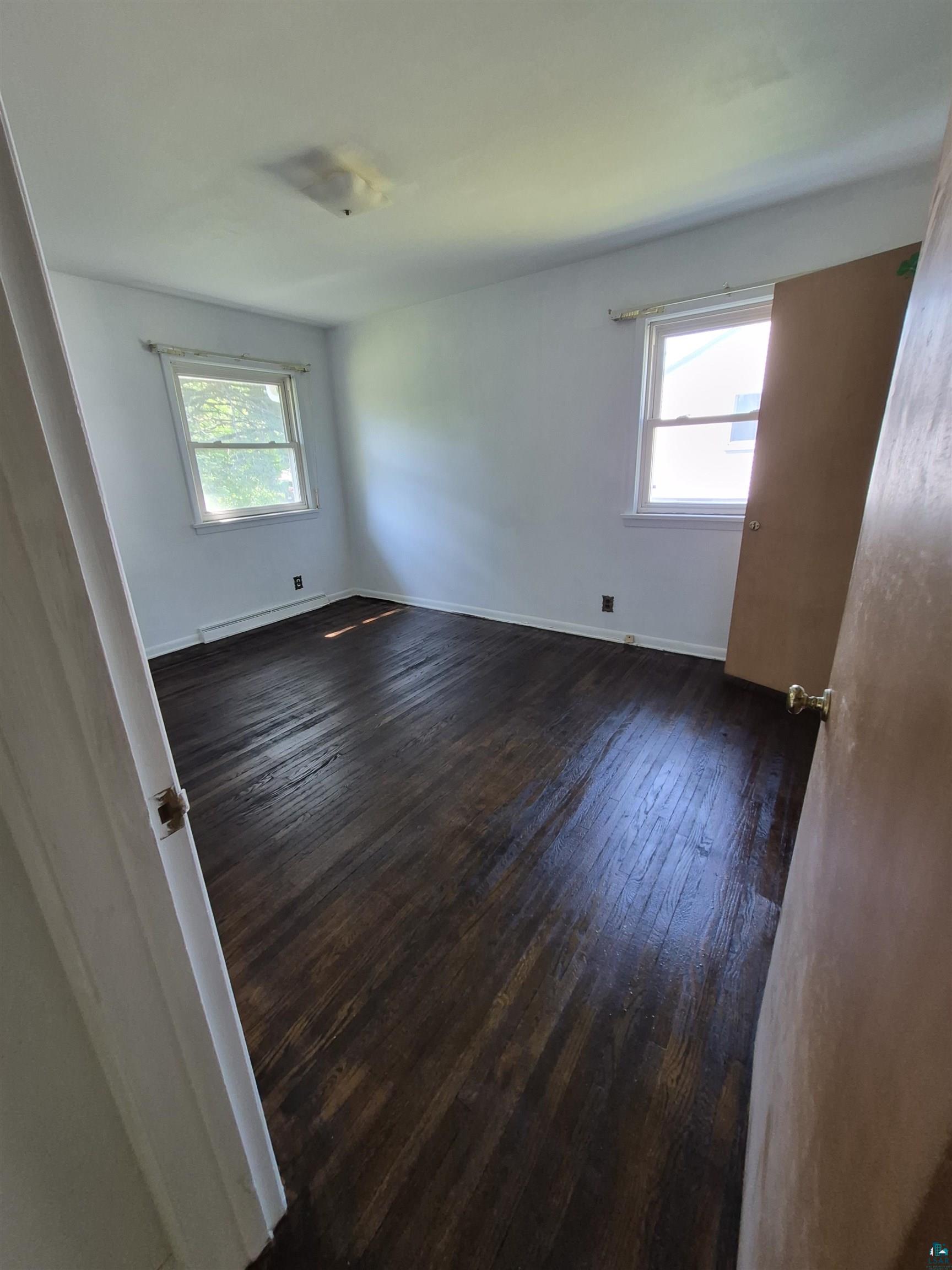 2109 West 22nd Street Duluth, MN 55811 - Photo 14 of 29 Room featuring dark wood-finish flooring, white painted walls, and a ceiling-mounted light fixture