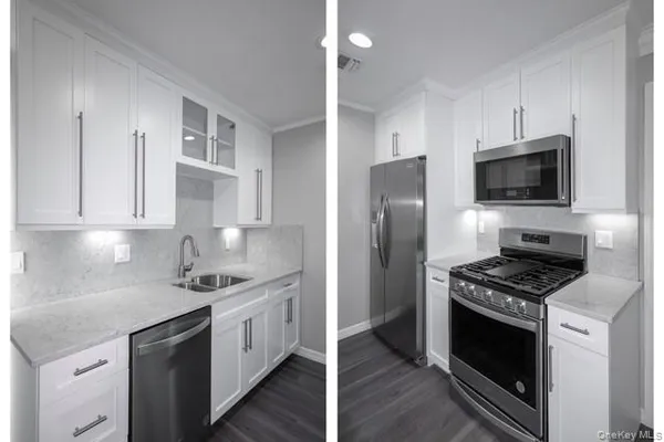 a kitchen with stainless steel appliances a white stove top oven a sink a refrigerator and cabinets