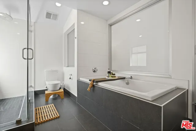 a spacious bathroom with a bathtub and a sink