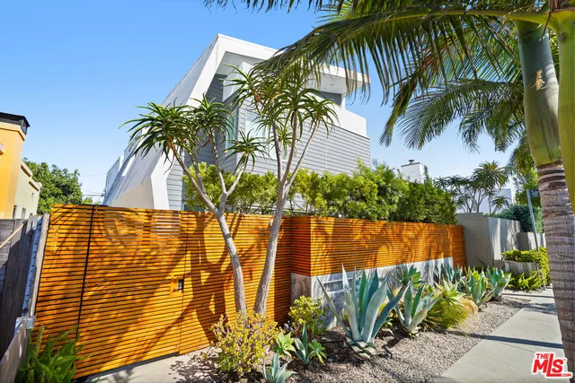 a view of swimming pool with a garden and plants