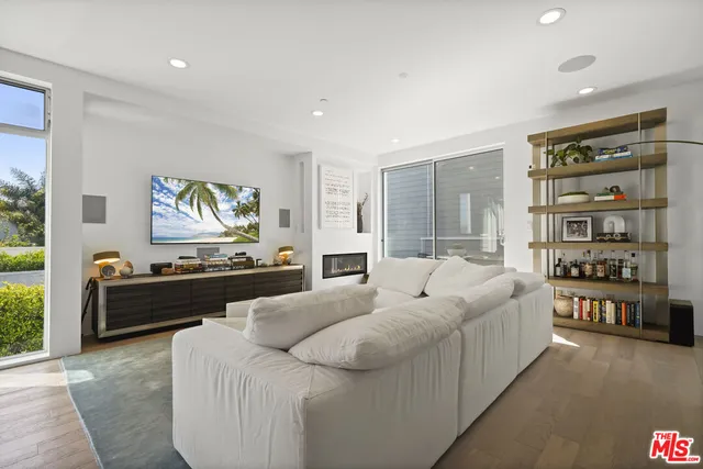 a living room with furniture fireplace and window
