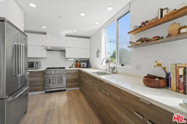 a kitchen with sink cabinets and stainless steel appliances