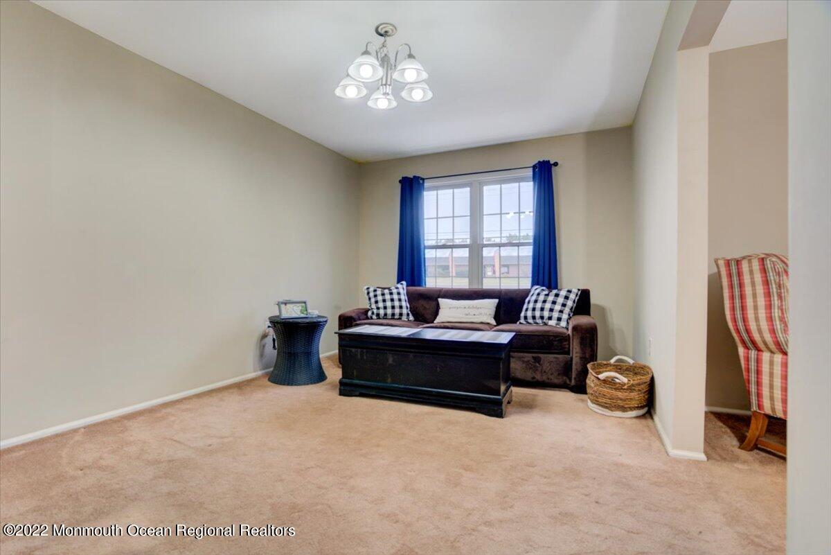 914 Monmouth Road Cream Ridge, NJ 08514 - Photo 12 of 17 a living room with furniture a chandelier and a window