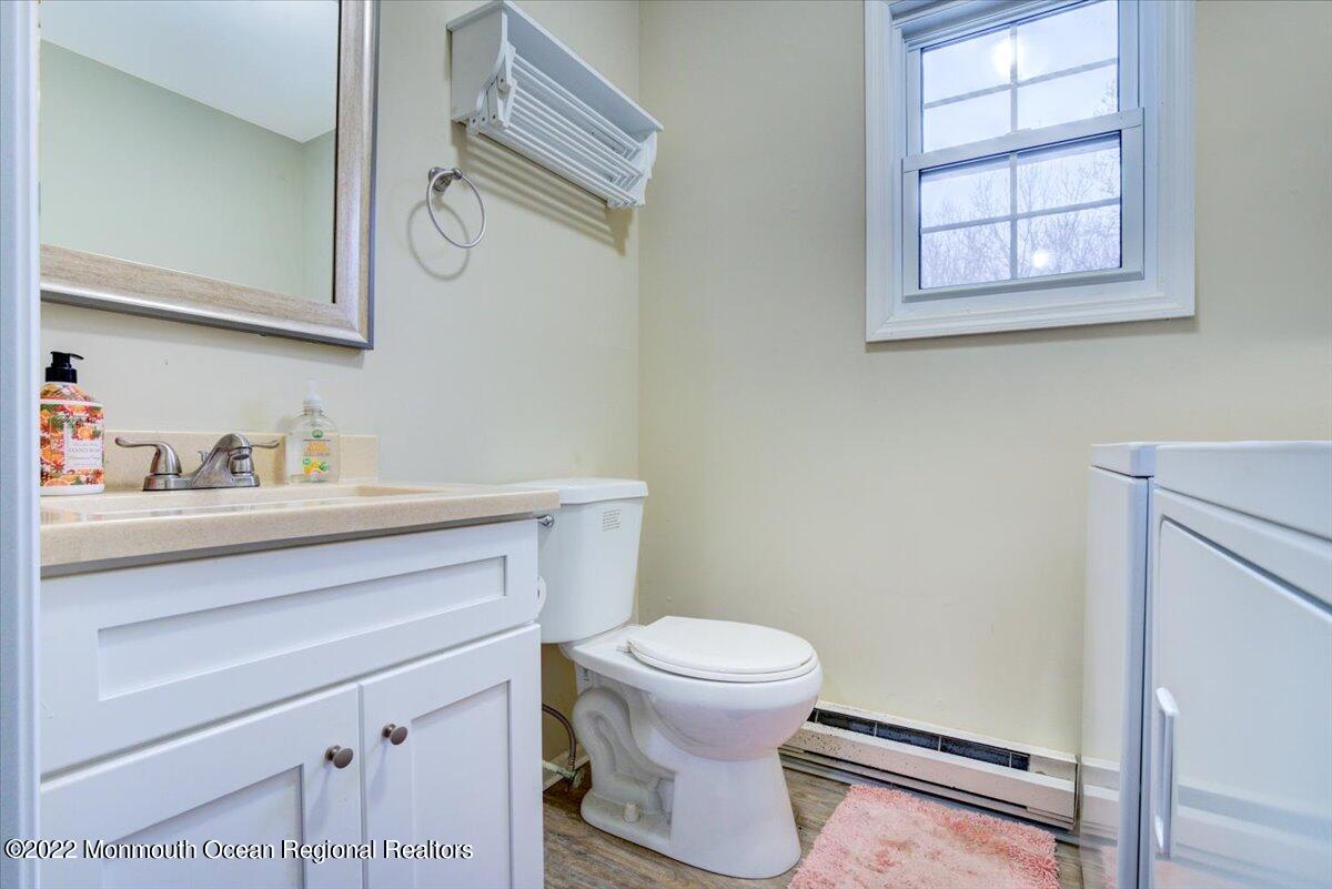 914 Monmouth Road Cream Ridge, NJ 08514 - Photo 17 of 17 a bathroom with a toilet sink and mirror