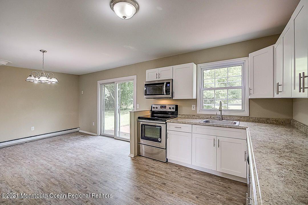 914 Monmouth Road Cream Ridge, NJ 08514 - Photo 3 of 17 a kitchen with stainless steel appliances granite countertop a stove a sink and a microwave