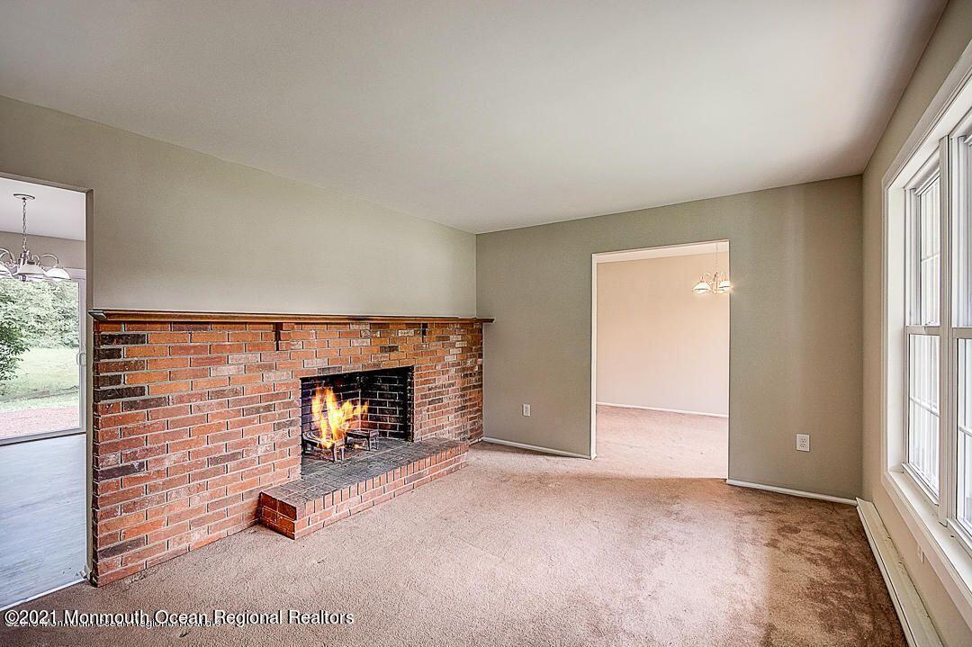 914 Monmouth Road Cream Ridge, NJ 08514 - Photo 4 of 17 a view of an empty room with a fireplace and window