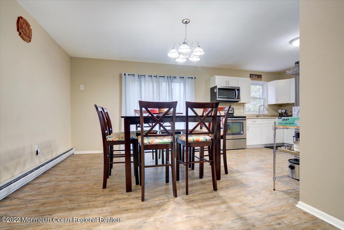 914 Monmouth Road Cream Ridge, NJ 08514 - Photo 8 of 17 a view of a dining room with furniture and chandelier