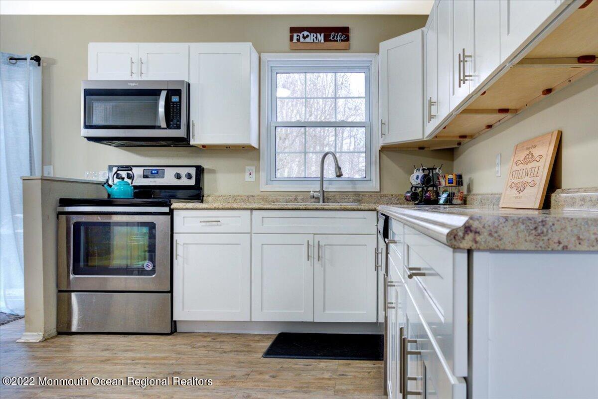 914 Monmouth Road Cream Ridge, NJ 08514 - Photo 10 of 17 a kitchen with stainless steel appliances granite countertop a stove a microwave and a sink