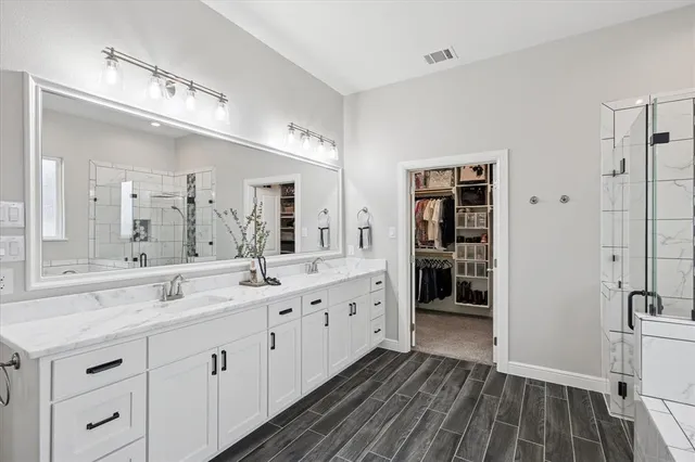 a bedroom with a bed and a lamp on the dresser