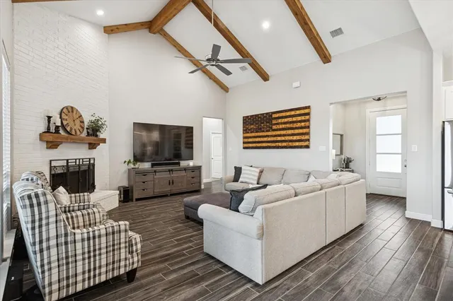 a kitchen with stainless steel appliances granite countertop a dining table chairs refrigerator and cabinets