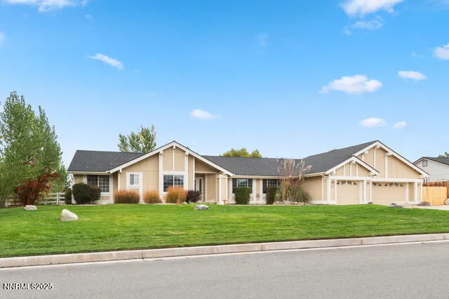 a view of a house next to a yard with big trees