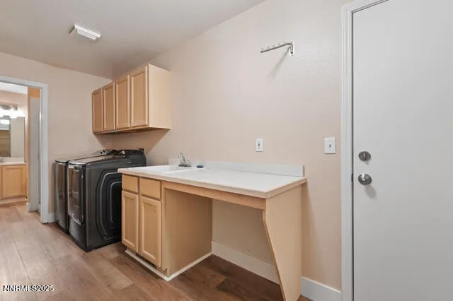 a utility room with cabinets washer and dryer