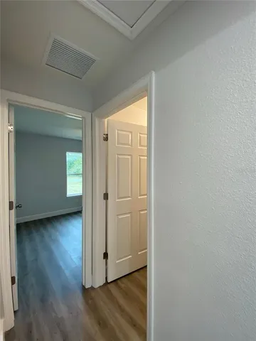a view of a livingroom with wooden floor and closet