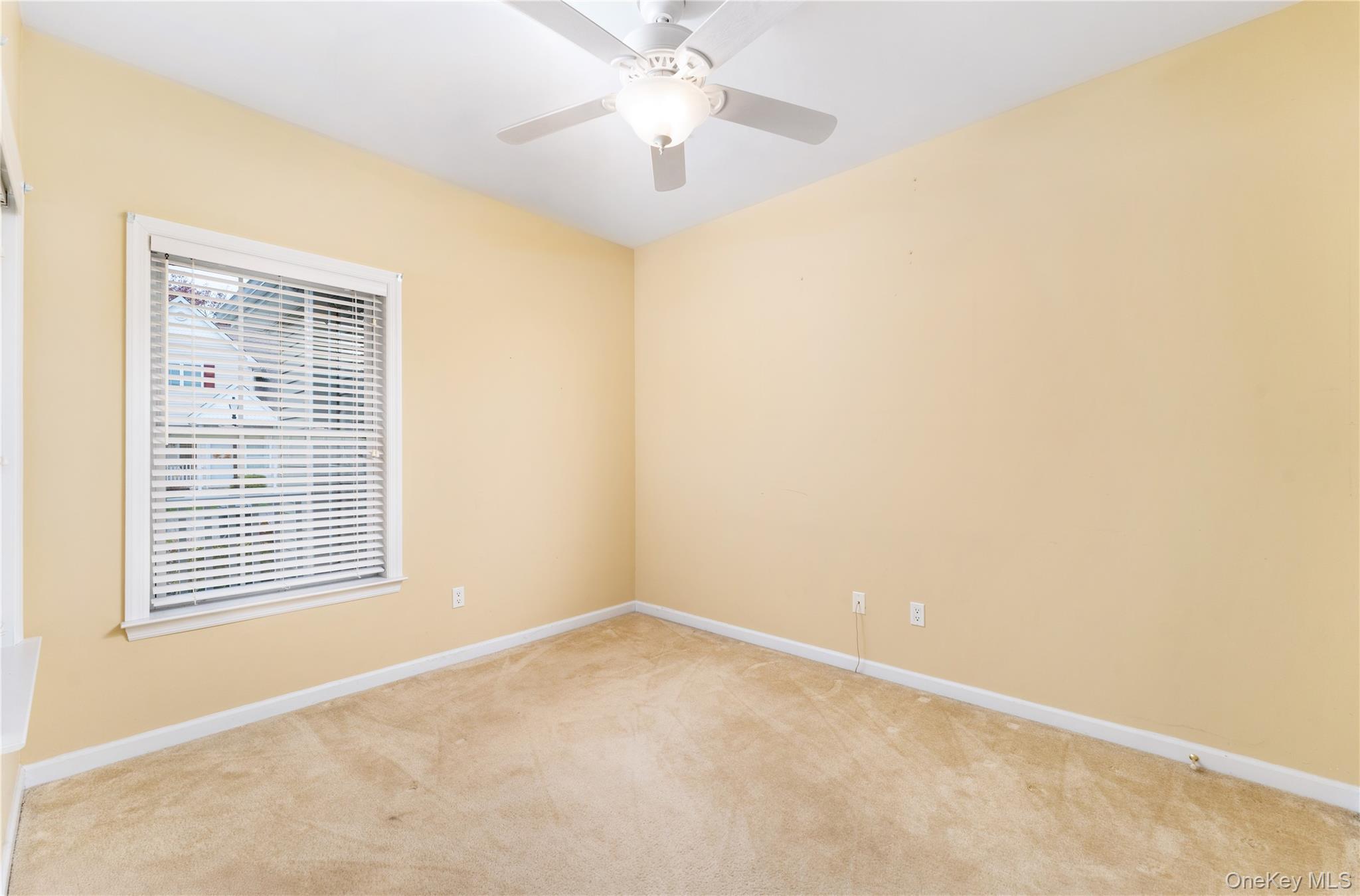 230 Ira Road, Unit 230 Mount Sinai, NY 11766 - Photo 11 of 38 a view of an empty room with a window