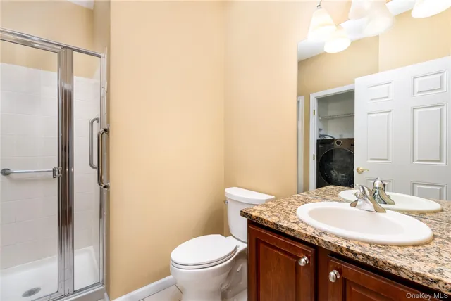 a bathroom with a granite countertop sink toilet and a mirror