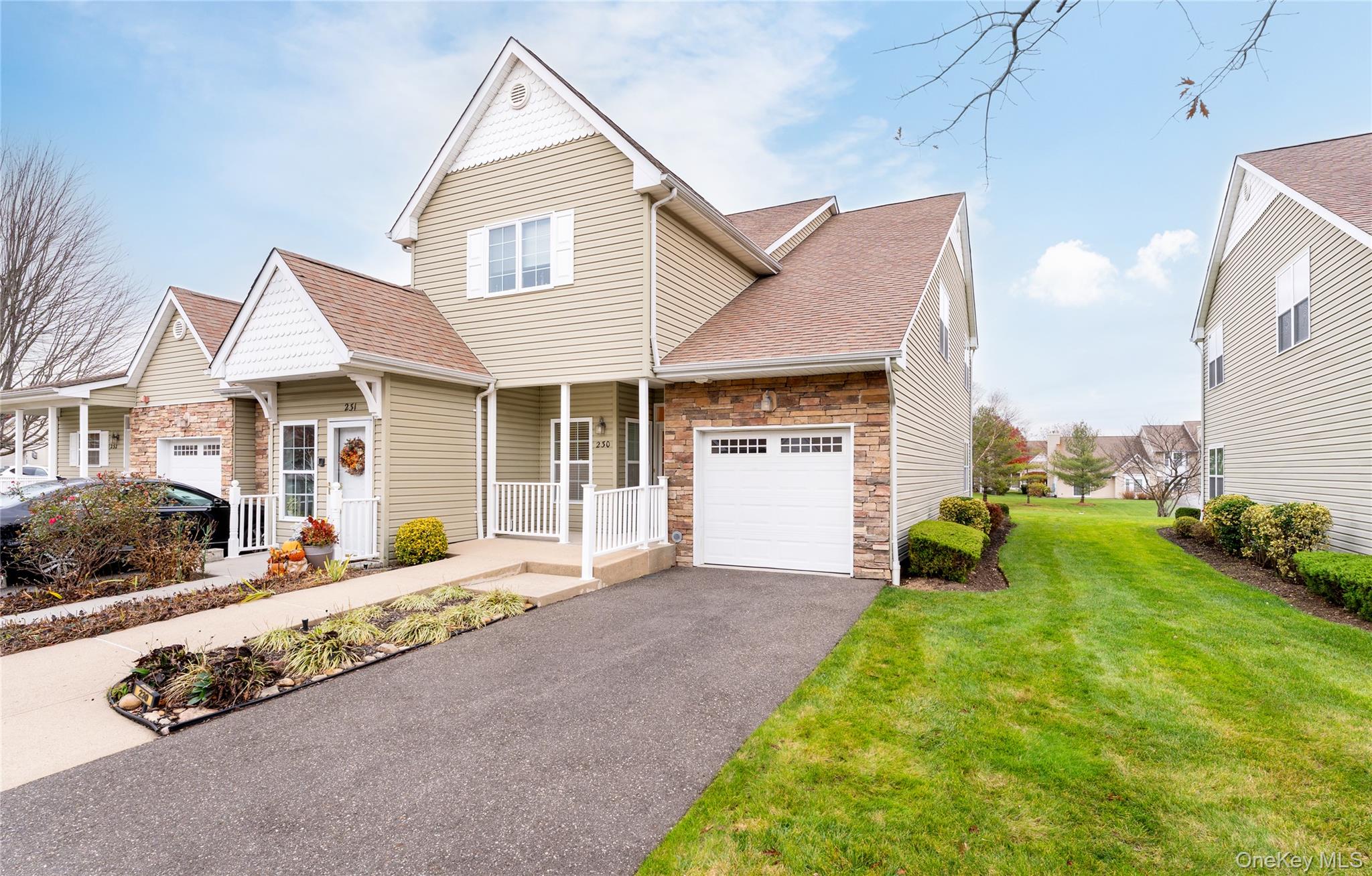 230 Ira Road, Unit 230 Mount Sinai, NY 11766 - Photo 2 of 38 a front view of a house with garden