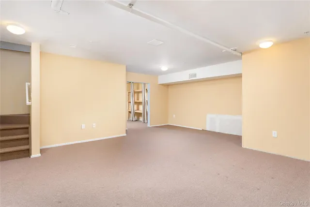 a view of a dining room and livingroom with furniture wooden floor a chandelier