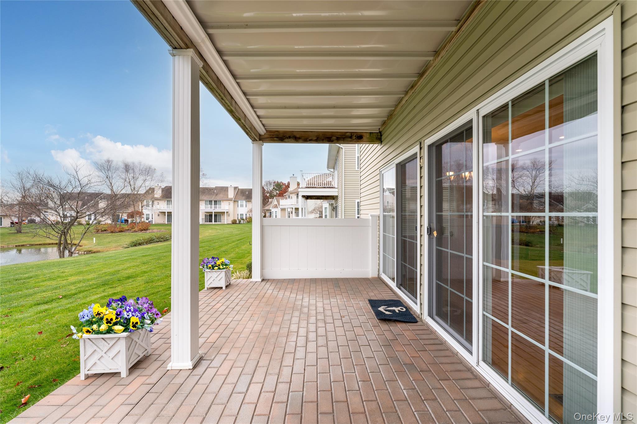 230 Ira Road, Unit 230 Mount Sinai, NY 11766 - Photo 24 of 38 a view of a porch with furniture and garden