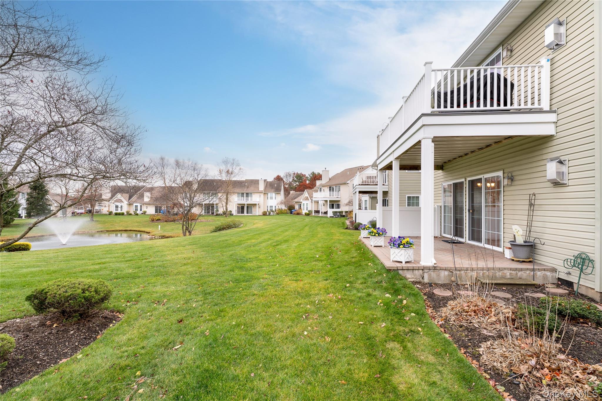 230 Ira Road, Unit 230 Mount Sinai, NY 11766 - Photo 27 of 38 a front view of a house with garden