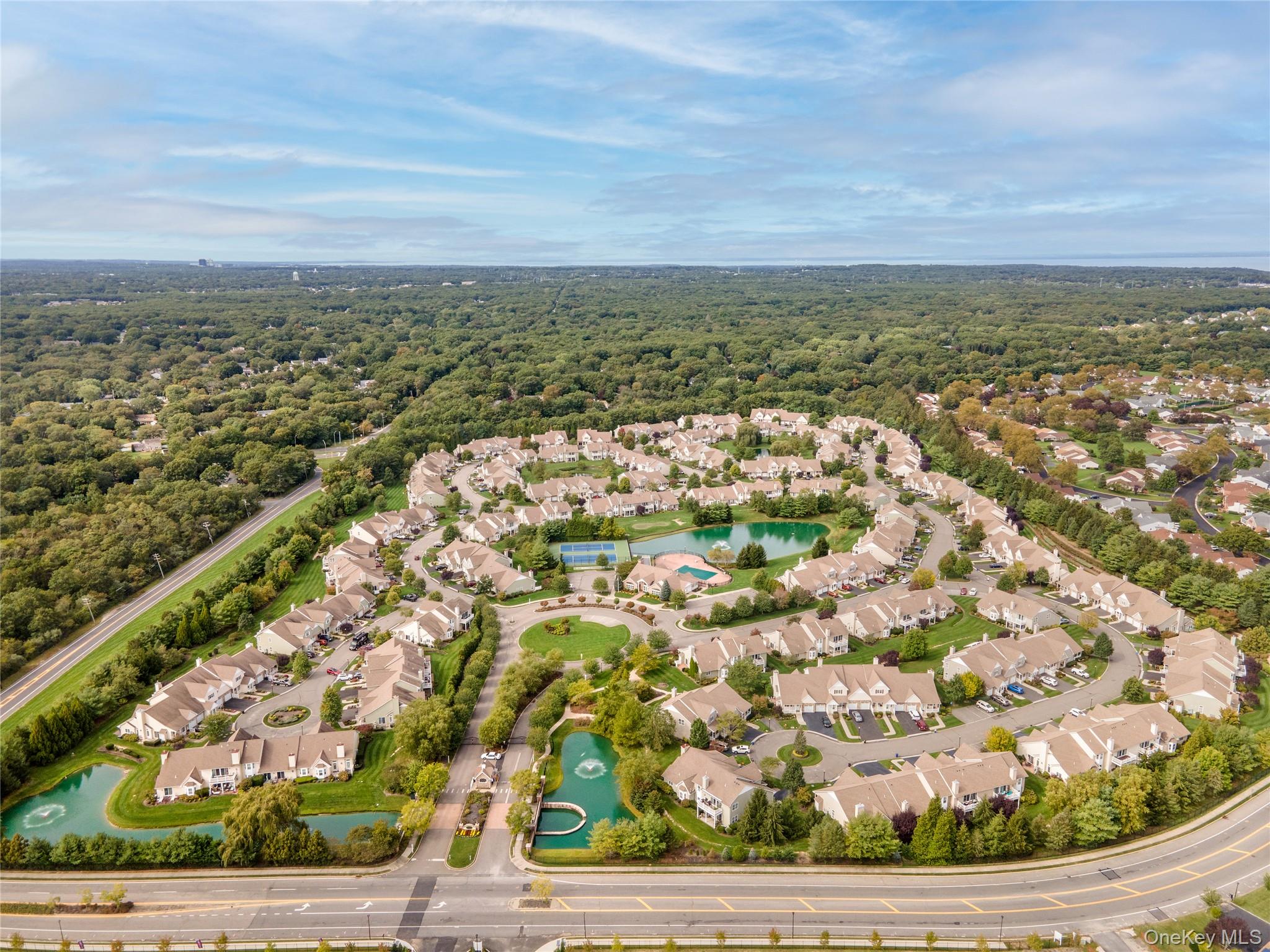 230 Ira Road, Unit 230 Mount Sinai, NY 11766 - Photo 36 of 38 an aerial view of residential building and lake
