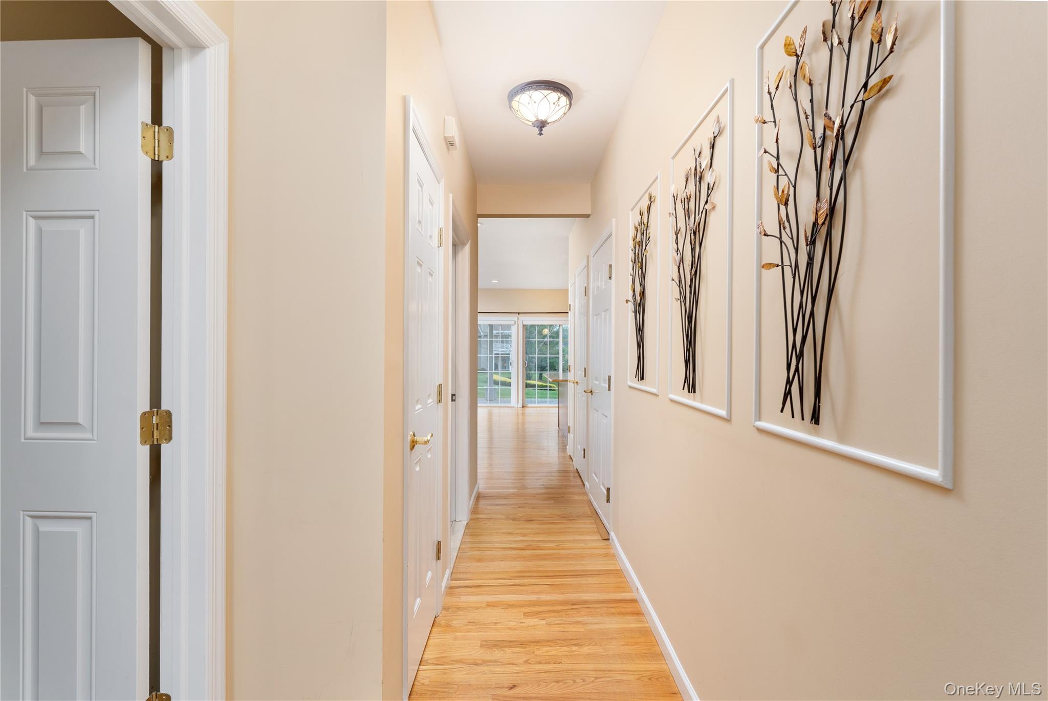 230 Ira Road, Unit 230 Mount Sinai, NY 11766 - Photo 4 of 38 a view of a hallway with wooden floor and a hallway