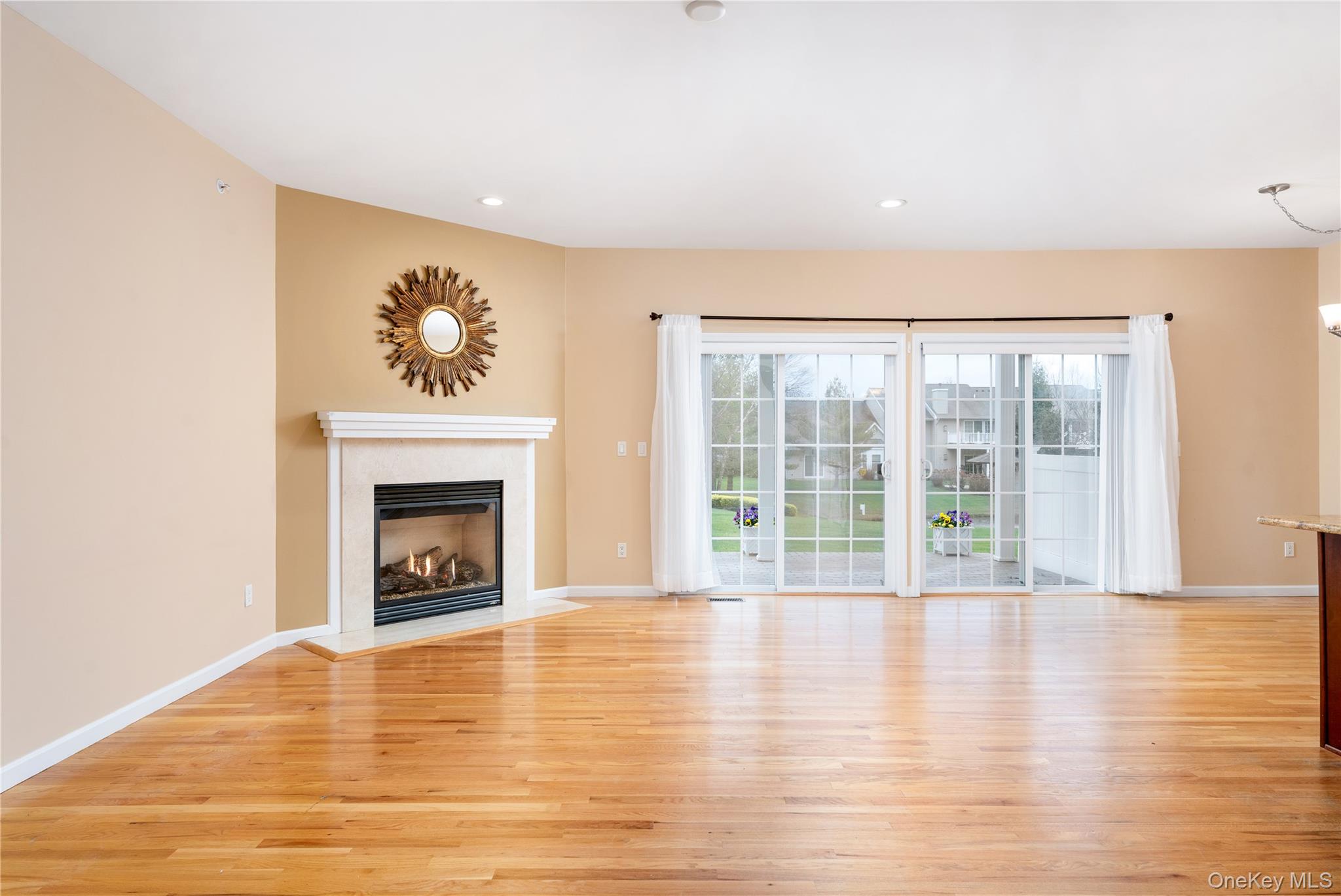 230 Ira Road, Unit 230 Mount Sinai, NY 11766 - Photo 5 of 38 a view of an empty room with wooden floor and a window