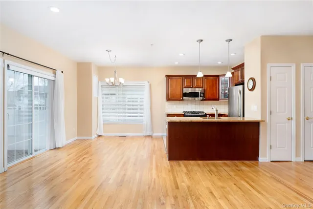 a view of a kitchen with a sink and a refrigerator