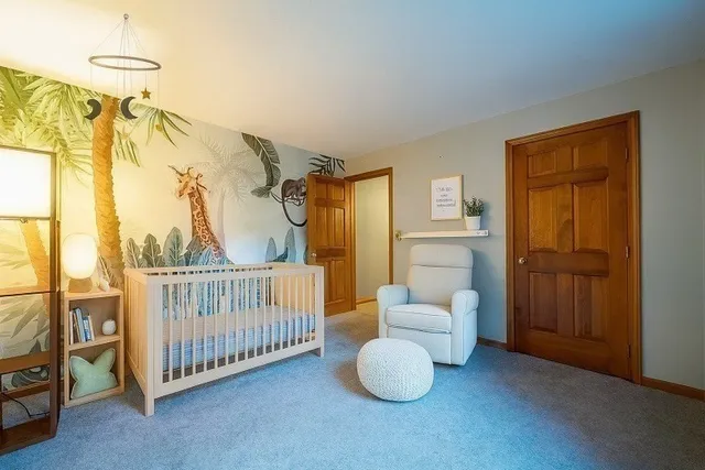 a bedroom with two beds and a window