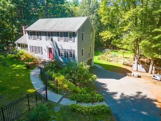 a aerial view of a house with a yard and potted plants