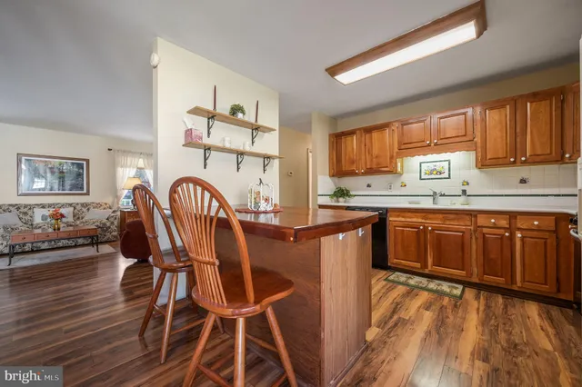 a kitchen with a table chairs in it and wooden floors