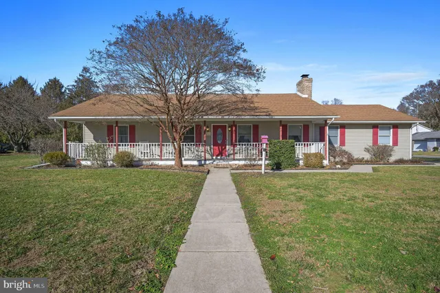 a front view of a house with a yard table and chairs
