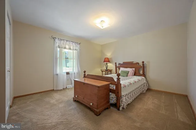 a bed room with a bed and a window