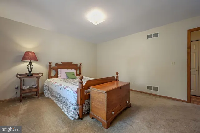 a bed room with a bed and a lamp