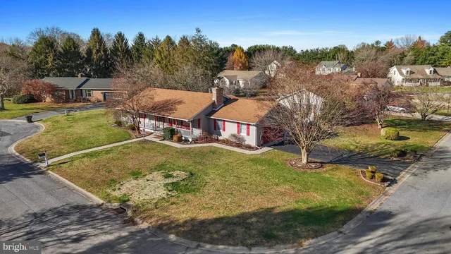 a house view with swimming pool in front of it