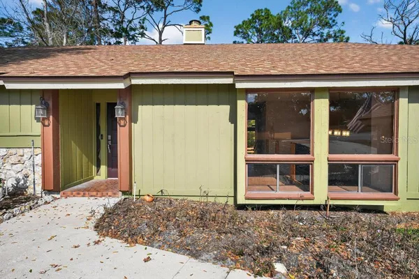 a view of empty room with wooden floor and window