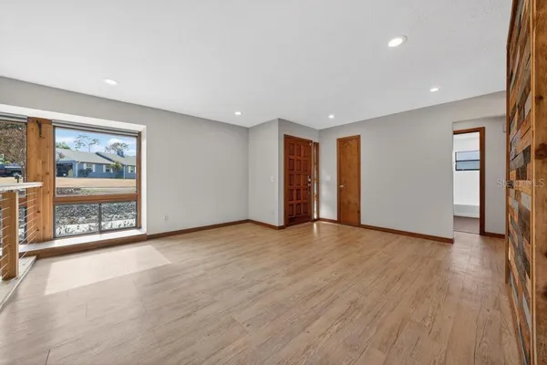 a view of a livingroom with wooden floor and a fireplace