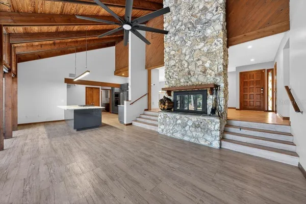 a kitchen with stainless steel appliances granite countertop a sink a stove and a refrigerator